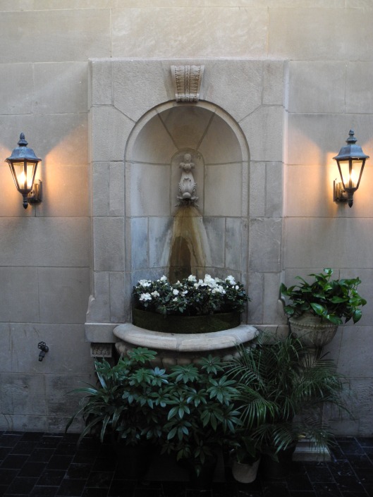 Stone fountain at an indoor courtyard.